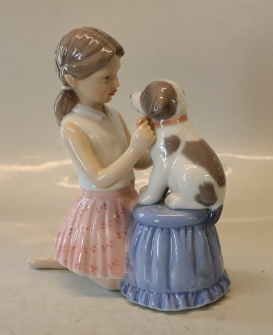 0452 RC Girl dressing a dog a butterfly 17 x 16 cm from the series animal pets (1249452) Royal Copenhagen