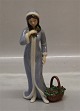 Royal Copenhagen figurine 554 RC Winter Day, Woman in winter dress with basket 
21 cm
